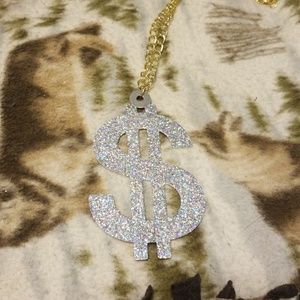 Metal glittery dollar sign costume piece.